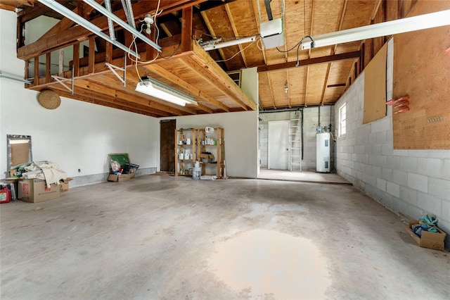 4700 NW 19th Pl, Gainesville, FL 32605 - garage featuring water heater, a garage door opener, and concrete block wall