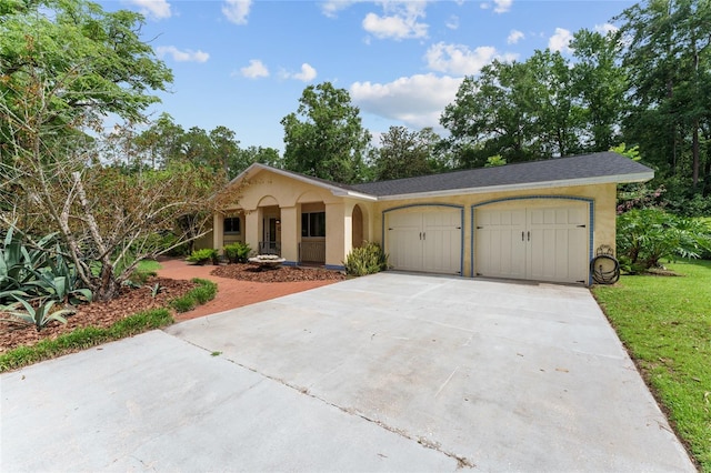 4700 NW 19th Pl, Gainesville, FL 32605 - view of front of home with a garage, concrete driveway, and stucco siding