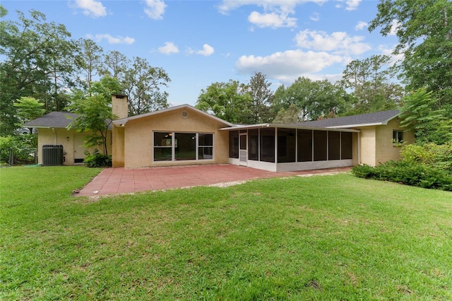 4700 NW 19th Pl, Gainesville, FL 32605 - rear view of property with a sunroom, stucco siding, a patio area, a yard, and a chimney