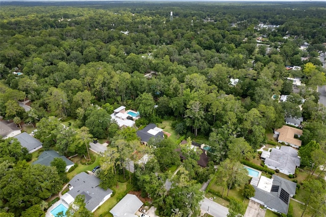 4700 NW 19th Pl, Gainesville, FL 32605 - aerial view of property and surrounding area with a heavily wooded area and nearby suburban area