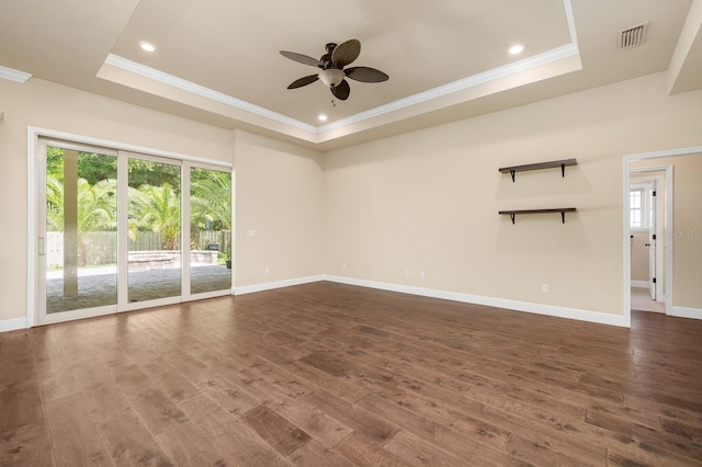 6316 SW 50th St, Gainesville, FL 32608 - spare room featuring a tray ceiling, healthy amount of natural light, dark wood-style floors, ornamental molding, and recessed lighting