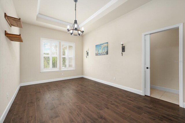 6316 SW 50th St, Gainesville, FL 32608 - spare room with a chandelier, dark wood finished floors, crown molding, and a tray ceiling