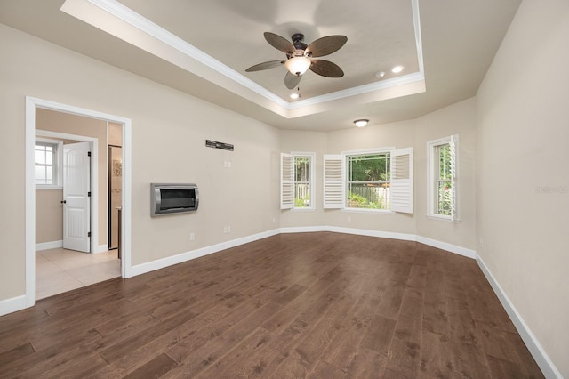 6316 SW 50th St, Gainesville, FL 32608 - unfurnished living room with crown molding, dark wood finished floors, a tray ceiling, healthy amount of natural light, and ceiling fan