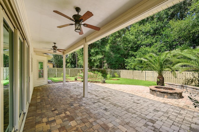 6316 SW 50th St, Gainesville, FL 32608 - fenced backyard with a patio, ceiling fan, and a fire pit