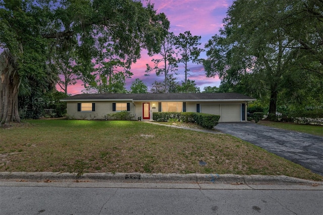 3331 NW 30th Ave, Gainesville, FL 32605 - ranch-style house featuring an attached garage, driveway, and a front yard