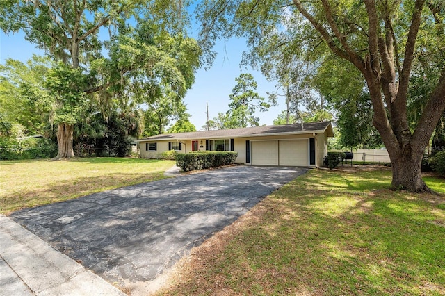 3331 NW 30th Ave, Gainesville, FL 32605 - ranch-style home with a garage and asphalt driveway