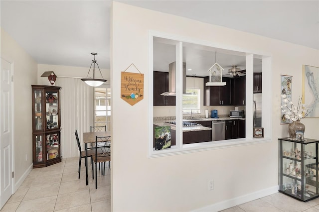 3331 NW 30th Ave, Gainesville, FL 32605 - kitchen featuring appliances with stainless steel finishes, light tile patterned floors, light countertops, and island range hood