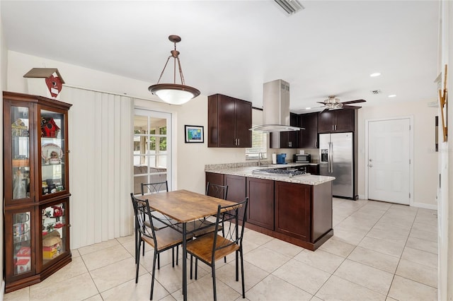 3331 NW 30th Ave, Gainesville, FL 32605 - kitchen with appliances with stainless steel finishes, island exhaust hood, a peninsula, light tile patterned floors, and dark brown cabinetry