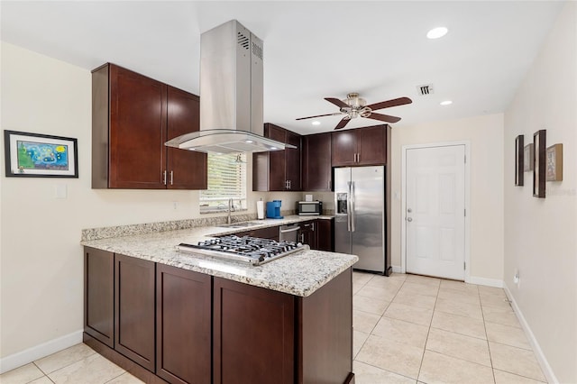 3331 NW 30th Ave, Gainesville, FL 32605 - kitchen featuring appliances with stainless steel finishes, island range hood, a peninsula, a ceiling fan, and light stone countertops