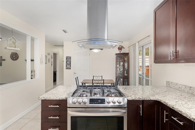 3331 NW 30th Ave, Gainesville, FL 32605 - kitchen with stainless steel gas range, island exhaust hood, light tile patterned flooring, and light stone counters