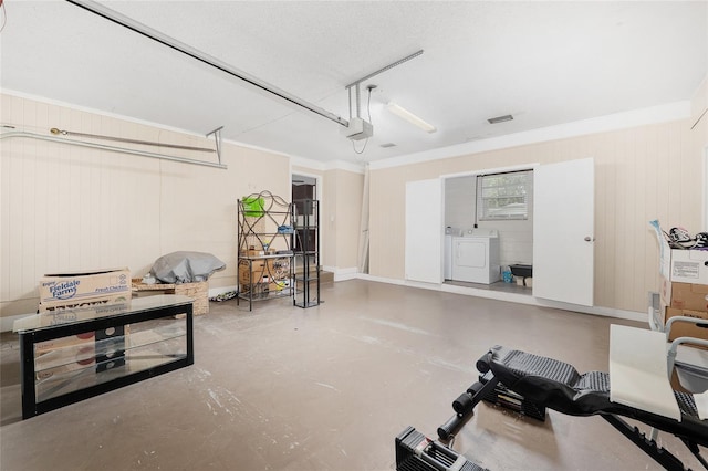 3331 NW 30th Ave, Gainesville, FL 32605 - garage with a garage door opener, washing machine and clothes dryer, and wood walls