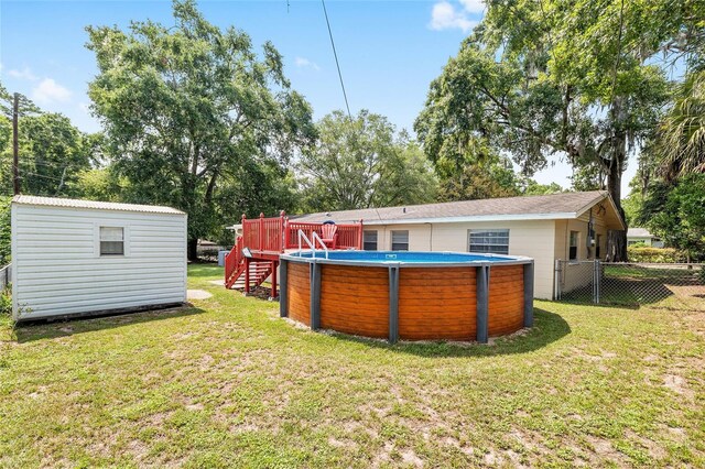 3331 NW 30th Ave, Gainesville, FL 32605 - rear view of house featuring an outdoor pool, a storage unit, and stairway