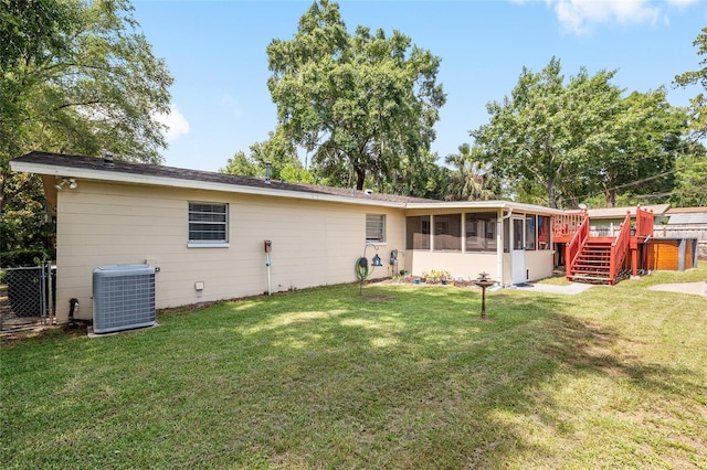 3331 NW 30th Ave, Gainesville, FL 32605 - back of property featuring a sunroom and a wooden deck