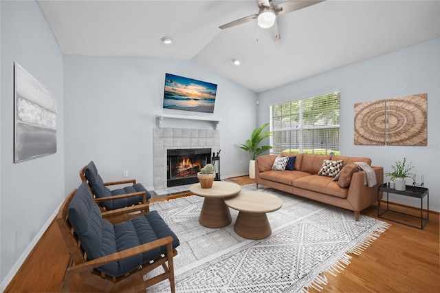 2829 SW 39th Ave, Gainesville, FL 32608 - living area featuring wood finished floors, a tile fireplace, vaulted ceiling, and a ceiling fan