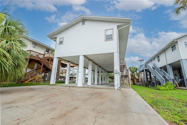 78 SE 901st Ave, Suwannee, FL 32692 - view of front of property with stairs, a carport, and concrete driveway