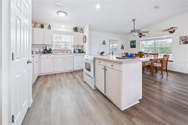 78 SE 901st Ave, Suwannee, FL 32692 - kitchen featuring white appliances, light wood-style flooring, light countertops, a ceiling fan, and healthy amount of natural light