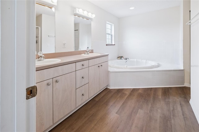 78 SE 901st Ave, Suwannee, FL 32692 - bathroom featuring wood finished floors, double vanity, and a garden tub