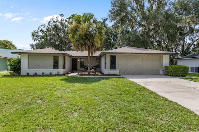 2330 NW 54th Ter, Gainesville, FL 32606 - ranch-style house with driveway, a garage, and a front lawn