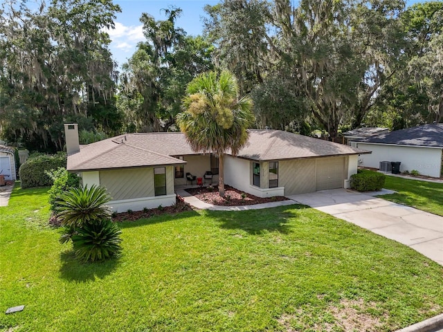 2330 NW 54th Ter, Gainesville, FL 32606 - ranch-style home with concrete driveway, a front lawn, a garage, and a chimney