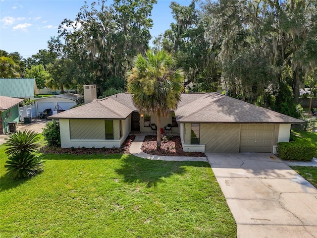 2330 NW 54th Ter, Gainesville, FL 32606 - view of front of property with concrete driveway, a front yard, an attached garage, and stucco siding