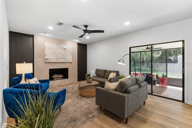 2330 NW 54th Ter, Gainesville, FL 32606 - living room featuring ceiling fan, light wood-type flooring, a fireplace, and recessed lighting