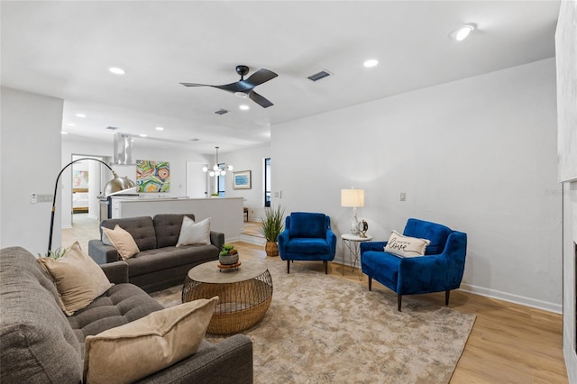2330 NW 54th Ter, Gainesville, FL 32606 - living area featuring light wood-style floors, a ceiling fan, a chandelier, and recessed lighting