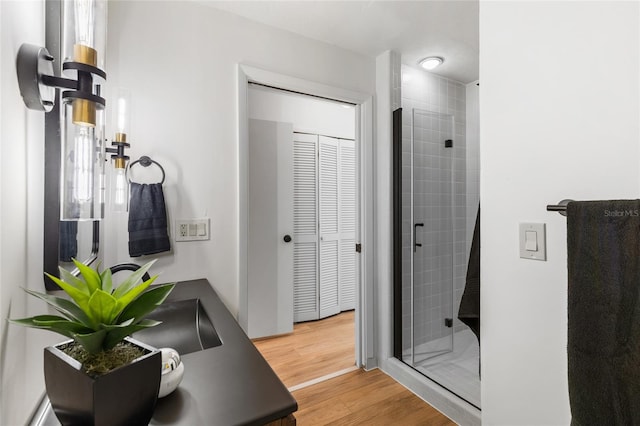 2330 NW 54th Ter, Gainesville, FL 32606 - bathroom featuring a stall shower, vanity, and wood finished floors