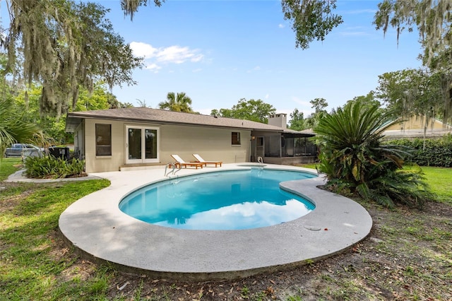 2330 NW 54th Ter, Gainesville, FL 32606 - view of pool with a sunroom and a patio