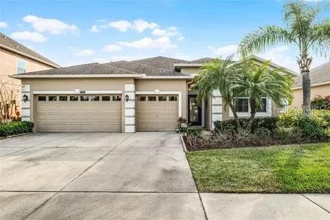 2048 Bristol Grande Way, Orlando, FL 32820 - view of front of property with a garage, concrete driveway, stucco siding, and a front lawn
