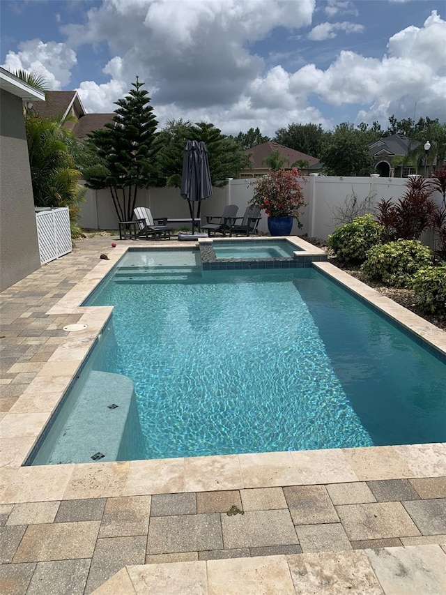 2048 Bristol Grande Way, Orlando, FL 32820 - view of swimming pool featuring a fenced backyard, a pool with connected hot tub, and a patio