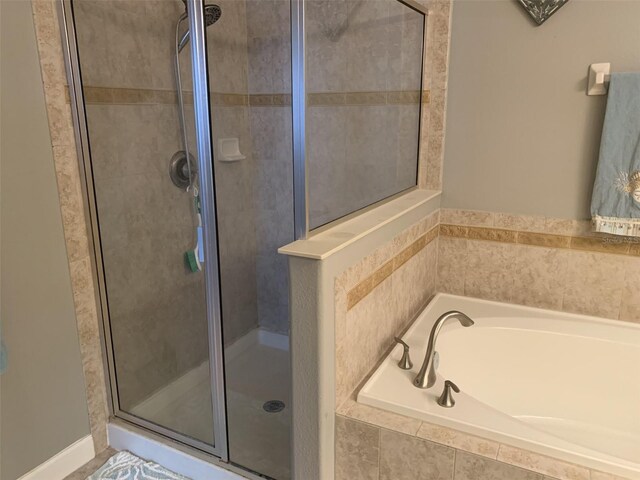 2048 Bristol Grande Way, Orlando, FL 32820 - full bathroom featuring a stall shower and a garden tub