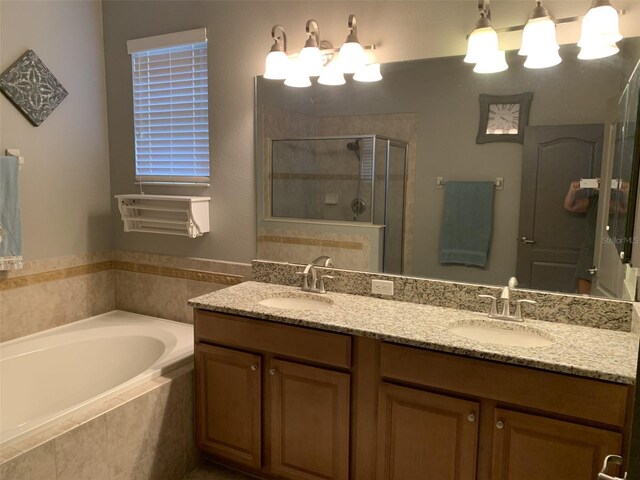 2048 Bristol Grande Way, Orlando, FL 32820 - bathroom featuring a shower stall, a bath, and double vanity
