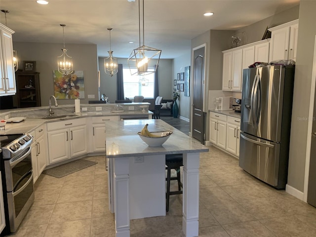 2048 Bristol Grande Way, Orlando, FL 32820 - kitchen featuring stainless steel appliances, a kitchen breakfast bar, white cabinetry, a kitchen island, and recessed lighting