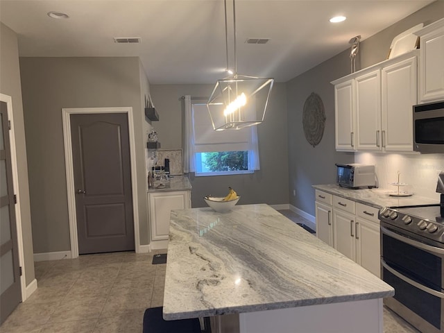 2048 Bristol Grande Way, Orlando, FL 32820 - kitchen featuring stainless steel appliances, a kitchen island, white cabinetry, light stone counters, and recessed lighting