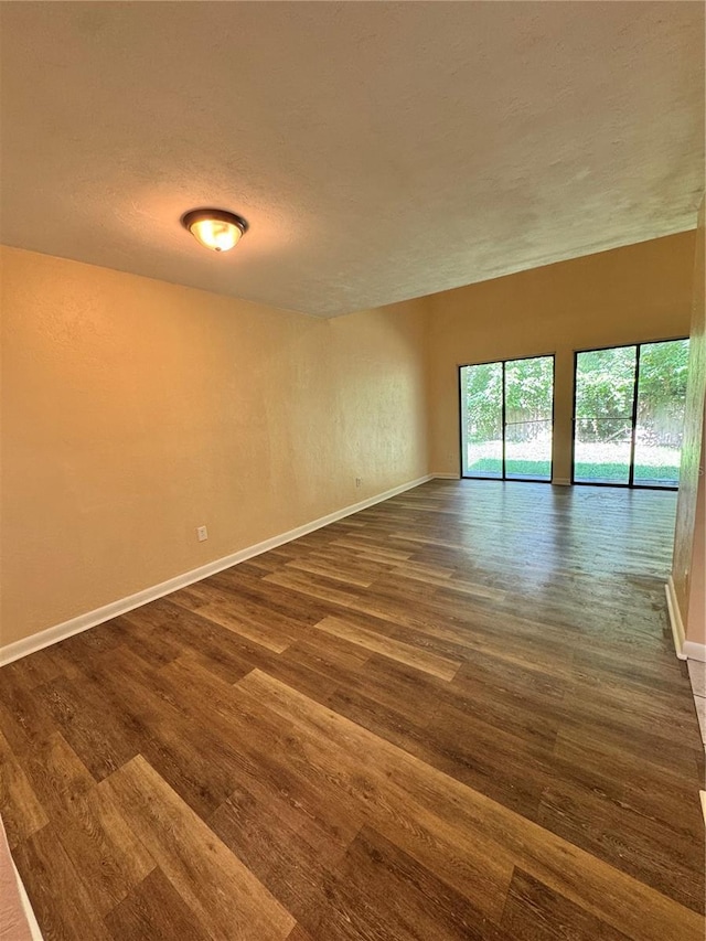 4224 SW 70th Ter Unit A, Gainesville, FL 32608 - unfurnished room featuring dark wood-style flooring and a textured ceiling