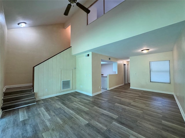 4224 SW 70th Ter Unit A, Gainesville, FL 32608 - unfurnished living room with a ceiling fan, a towering ceiling, wood finished floors, and stairway