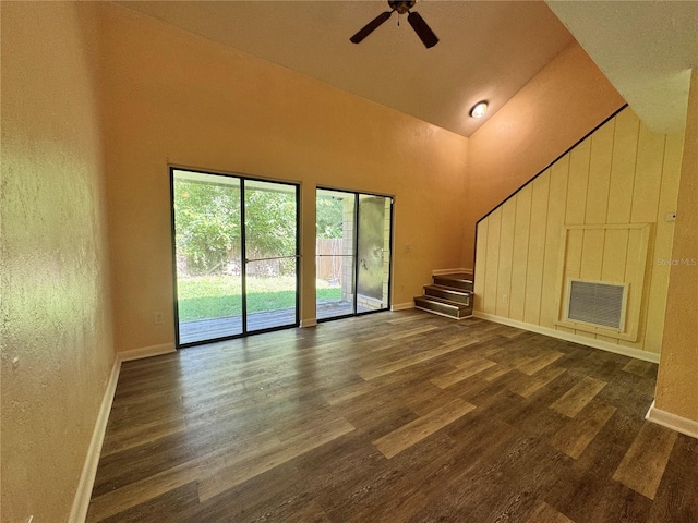 4224 SW 70th Ter Unit A, Gainesville, FL 32608 - unfurnished living room with stairs, dark wood-style floors, high vaulted ceiling, and ceiling fan