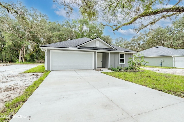 1262 Coral Farms Rd, Florahome, FL 32140 - single story home featuring board and batten siding, driveway, an attached garage, and roof with shingles