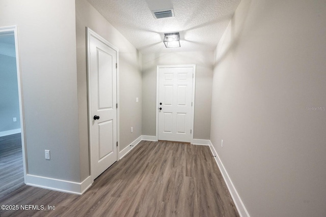 1262 Coral Farms Rd, Florahome, FL 32140 - hallway featuring wood finished floors and a textured ceiling