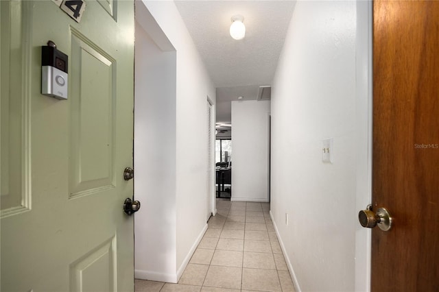 3434 NW 21st Dr Unit D4, Gainesville, FL 32605 - hallway featuring light tile patterned floors and a textured ceiling