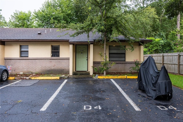 3434 NW 21st Dr Unit D4, Gainesville, FL 32605 - view of front of house with stucco siding, brick siding, and uncovered parking