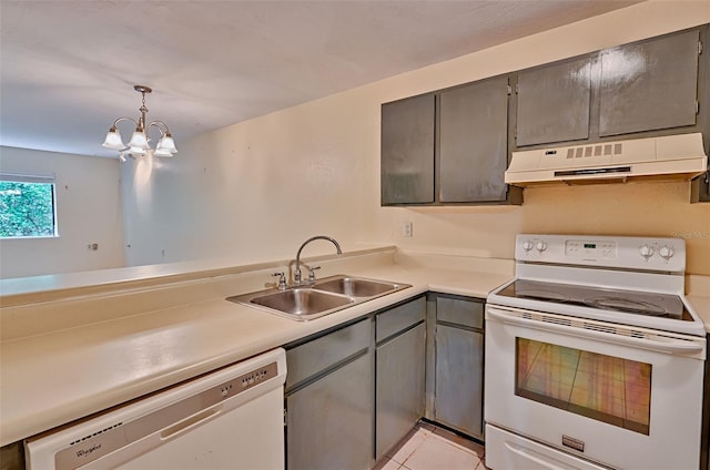 89 SE 16th Ave Unit P102, Gainesville, FL 32601 - kitchen with white appliances, under cabinet range hood, gray cabinets, light countertops, and a chandelier