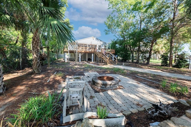145 SE 904th Ave, Suwannee, FL 32692 - view of yard featuring stairway, a fire pit, a wooden deck, and a patio area