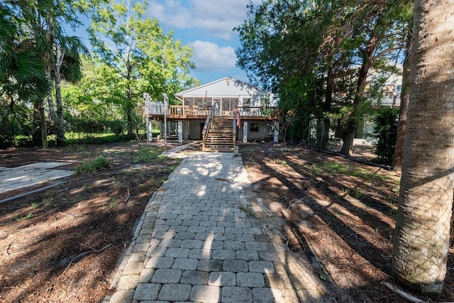 145 SE 904th Ave, Suwannee, FL 32692 - back of house with stairway, decorative driveway, and a wooden deck