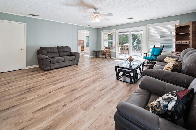 145 SE 904th Ave, Suwannee, FL 32692 - living area with ceiling fan, a textured ceiling, light wood-style floors, and crown molding