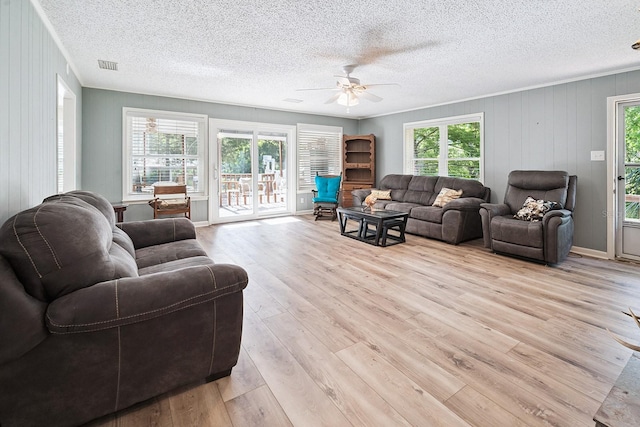 145 SE 904th Ave, Suwannee, FL 32692 - living area featuring plenty of natural light, ceiling fan, light wood-style floors, and a textured ceiling