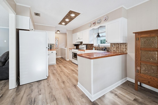 145 SE 904th Ave, Suwannee, FL 32692 - kitchen featuring white appliances, crown molding, butcher block countertops, light wood-type flooring, and a peninsula