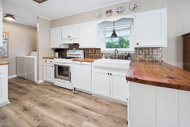 145 SE 904th Ave, Suwannee, FL 32692 - kitchen featuring white appliances, washer and dryer, wooden counters, decorative backsplash, and ornamental molding