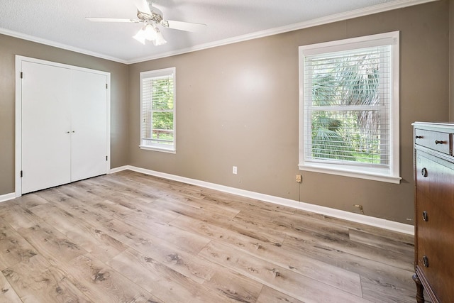 145 SE 904th Ave, Suwannee, FL 32692 - unfurnished bedroom with crown molding, multiple windows, wood finished floors, and a ceiling fan
