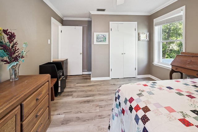 145 SE 904th Ave, Suwannee, FL 32692 - bedroom featuring light wood-type flooring, crown molding, a closet, and a desk